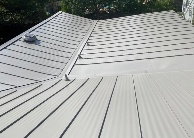 Solar attic fan installed on a metal roof for Roof Ventilation in Kalamazoo